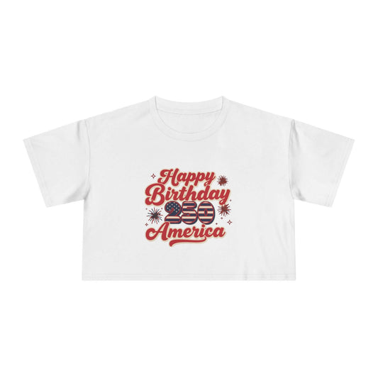 Patriotic women's crop tee featuring a vintage-inspired design that says 'Happy Birthday America' with stars and stripes.
