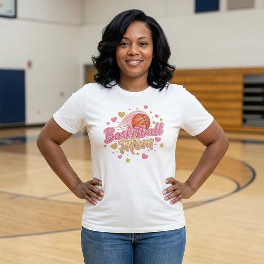 Woman in Basketball Mom shirt smiling on court, celebrating her love for basketball and motherhood.