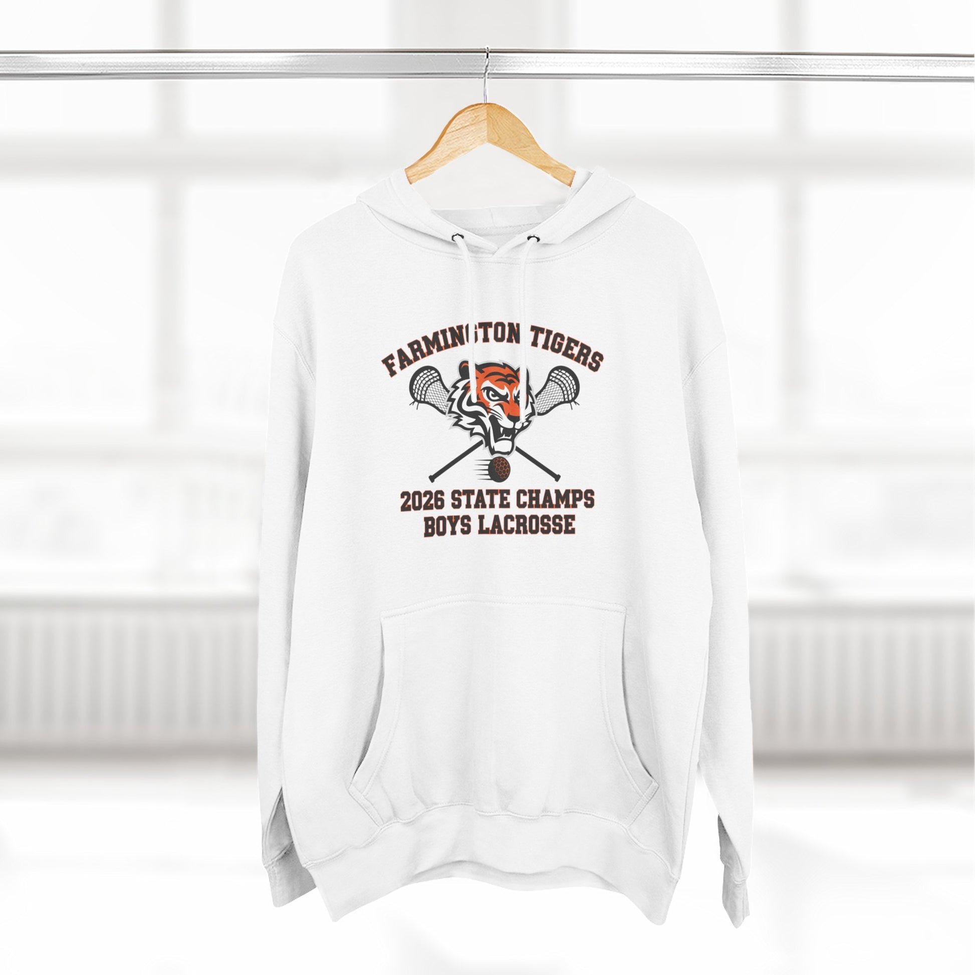 Farmington Tigers 2026 State Champs Boys Lacrosse Fleece Hoodie displayed on a hanger in a bright room.